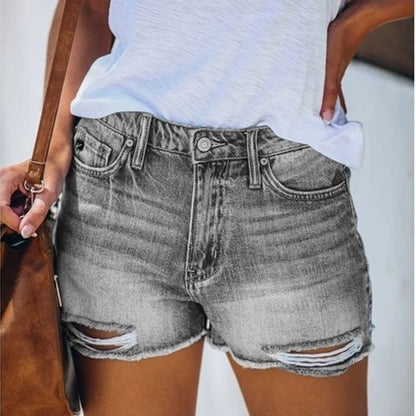 "fringe denim shorts on-model street styling with raw hem fringe in blue, quiet luxury vibe for casual city days"