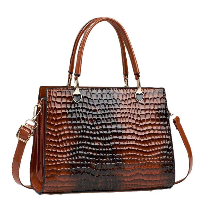 Brown textured handbag with shoulder strap on a white background