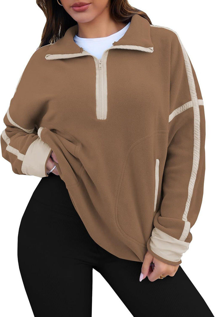 Brown fleece pullover with white accents worn by a person on a white background
