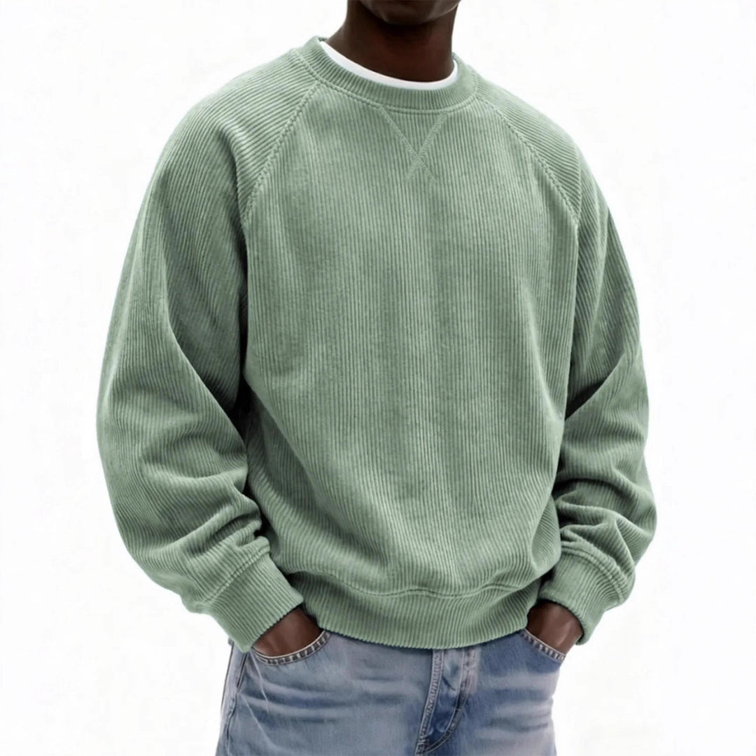Person wearing a green corduroy sweatshirt on a white background