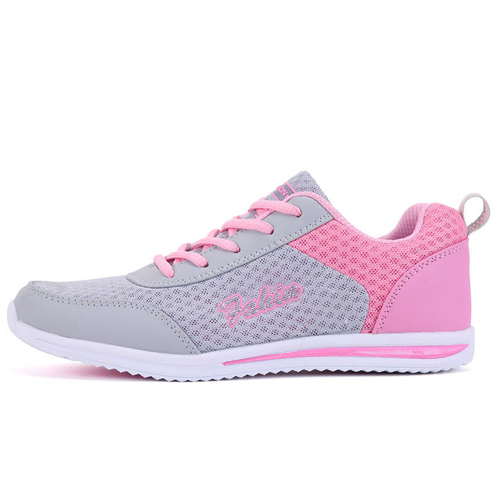 Gray and pink lace-up shoe in a side angle on white, showing the pink laces, gray mesh upper, heel loop and pink sole stripe.