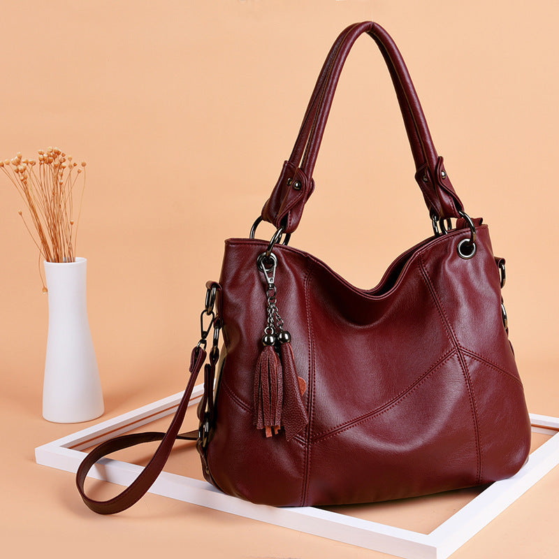 Wine red tassel bucket crossbody bag swinging on shoulder European retro style daily wear