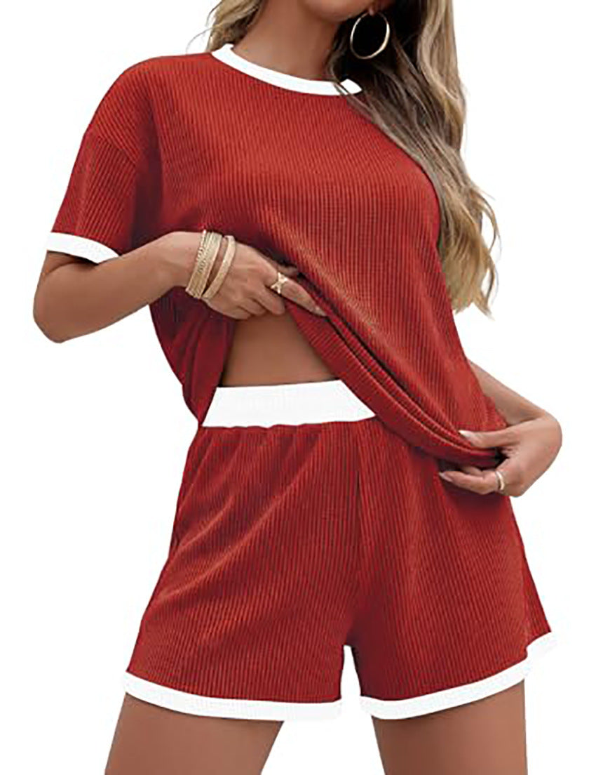 Red ribbed knit two-piece set with white trim on a white background