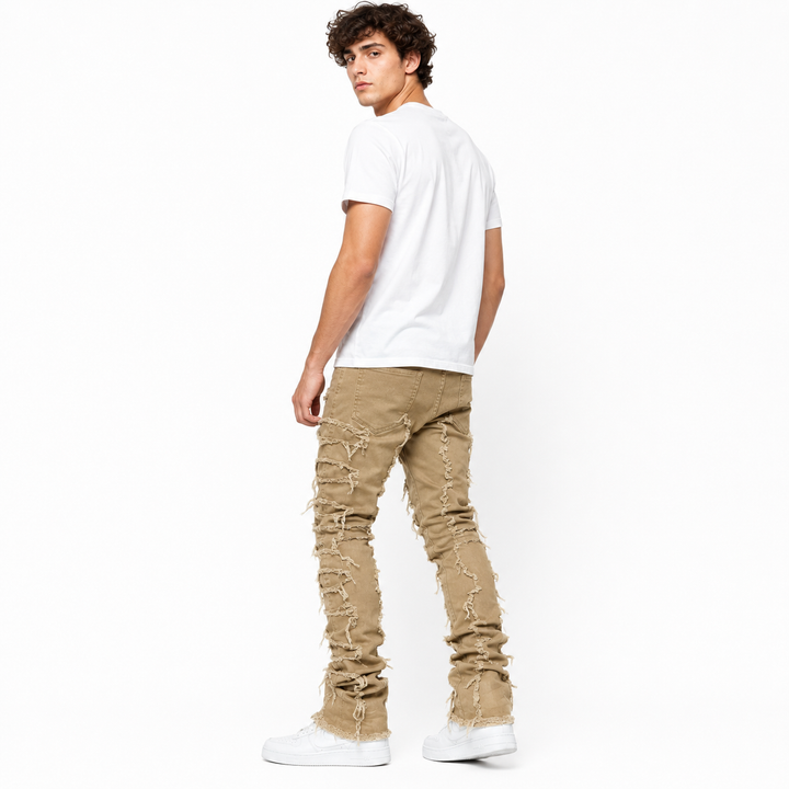 Mens ripped fringe jeans with slim silhouette and sneaker-friendly stacked hem