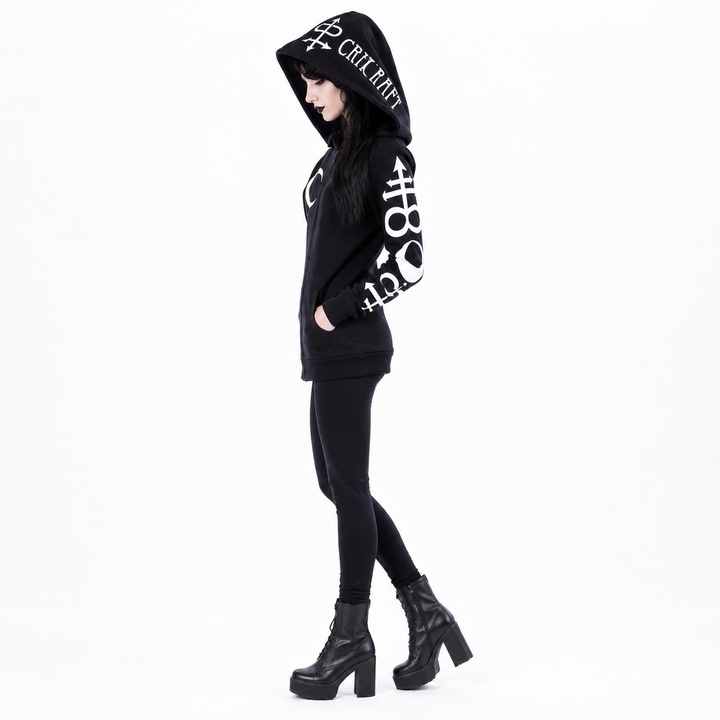 A model wearing a black hooded sweatshirt with white graphic text and symbols, paired with black leggings and black platform ankle boots, shown against a plain white background.
