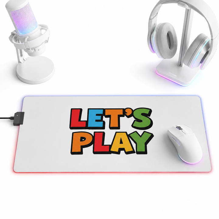 RGB LED gaming mouse pad with a smooth polyester top for accurate mouse movement and a secure non-slip rubber base on a desk.
