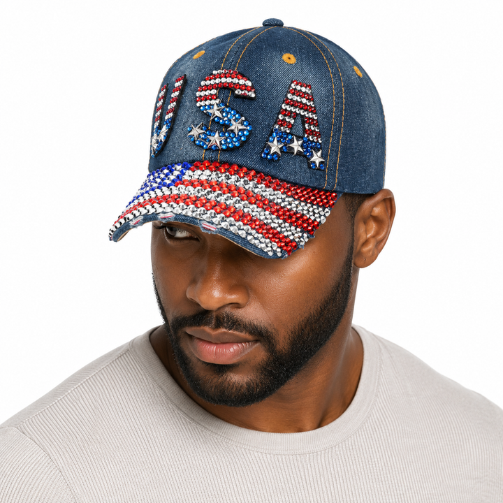 Close-up of red, white and blue rhinestones on a navy washed denim baseball cap designed for USA fans and game watch parties.
