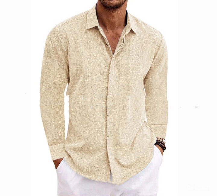 Man wearing a beige linen shirt and white pants on a white background