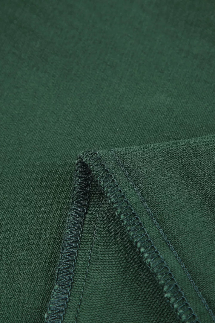 Close-up of green fabric with a visible seam