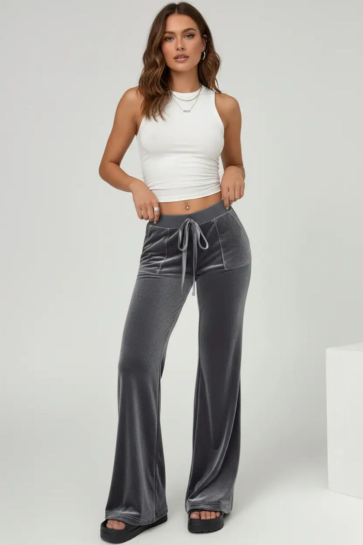 velvet flare pants side pocket detail close up premium finish indoors