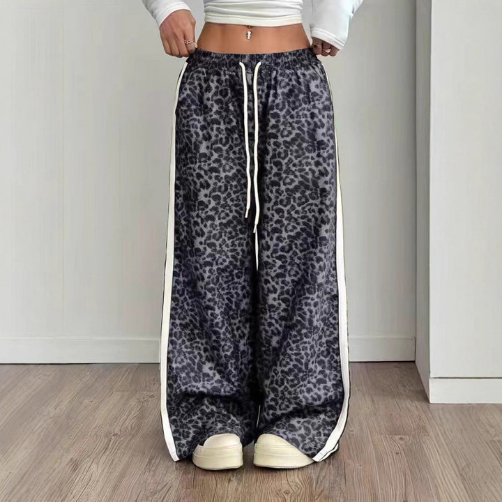 Leopard print pants with white drawstring and trim on a plain background