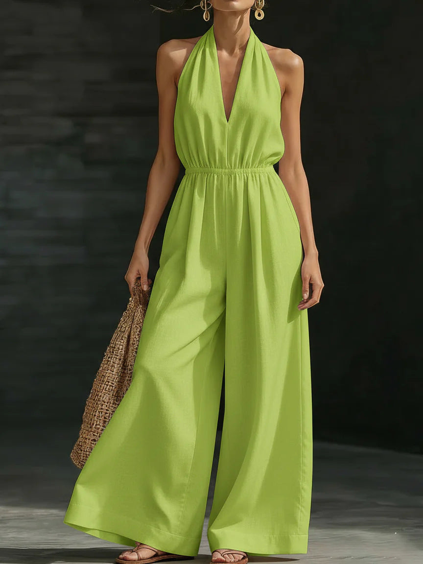 Woman wearing a bright green jumpsuit against a dark background