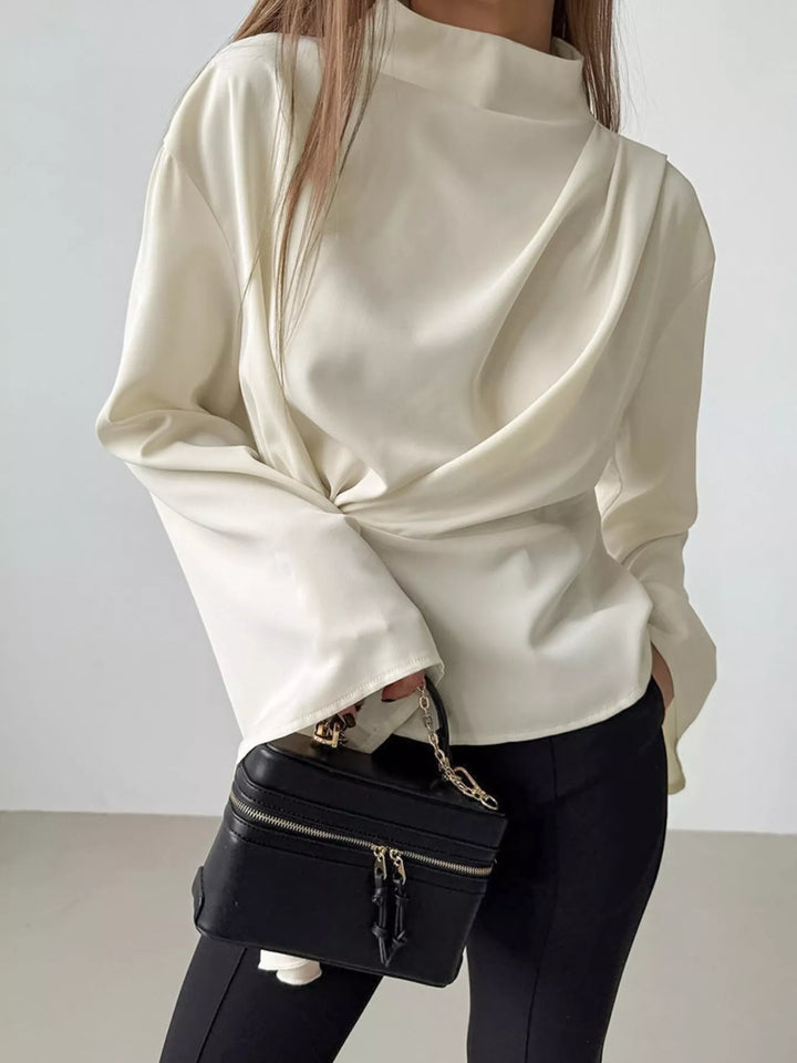 Ruched mock neck blouse zipper closure detail at back long sleeve mock neck top on hanger in smooth polyester
