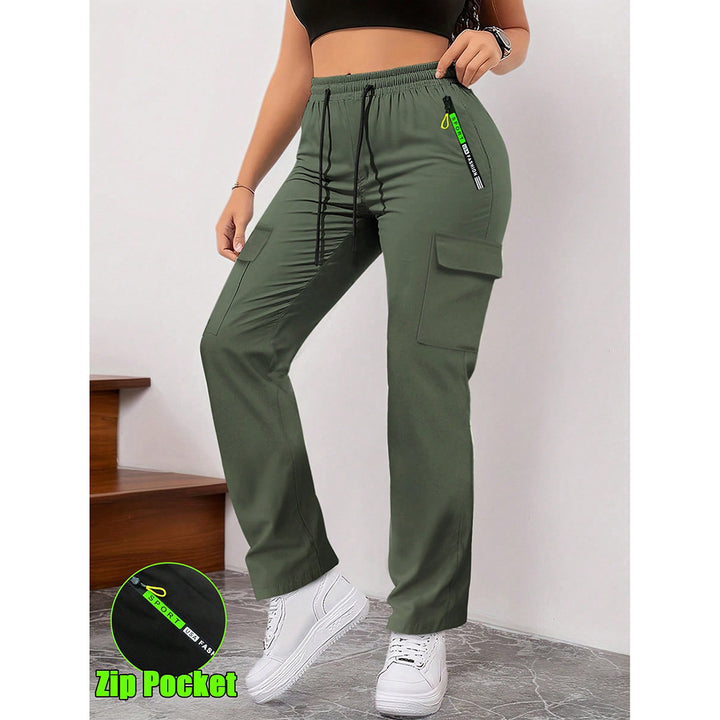 Green cargo pants with a visible zip pocket worn by a person on a plain background