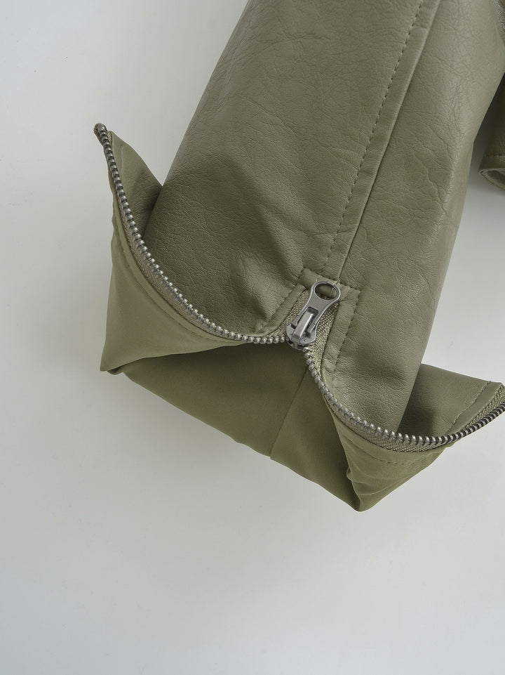Gray Green sleeve cuff close-up, showing an opened zipper, with visible stitching and the folded sleeve edge in close detail.