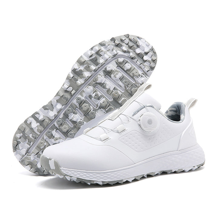 White and gray rotary buckle footwear with one sole facing forward, revealing the molded tread pattern on a white background.