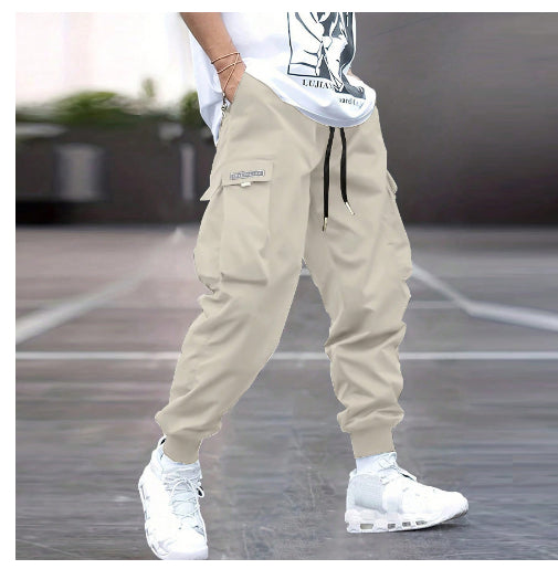 Person wearing beige cargo pants and white sneakers on a blurred background