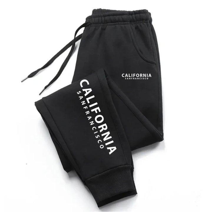 Black graphic sweatpants with California lettering, matching drawstrings and ankle cuffs, folded on a clean white background.