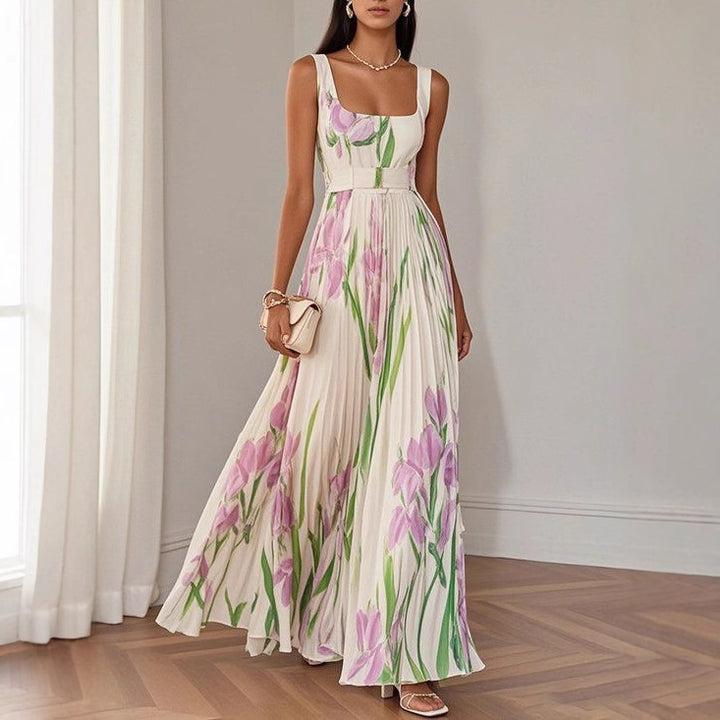 Woman wearing a floral dress in a room with white walls and wooden floor.