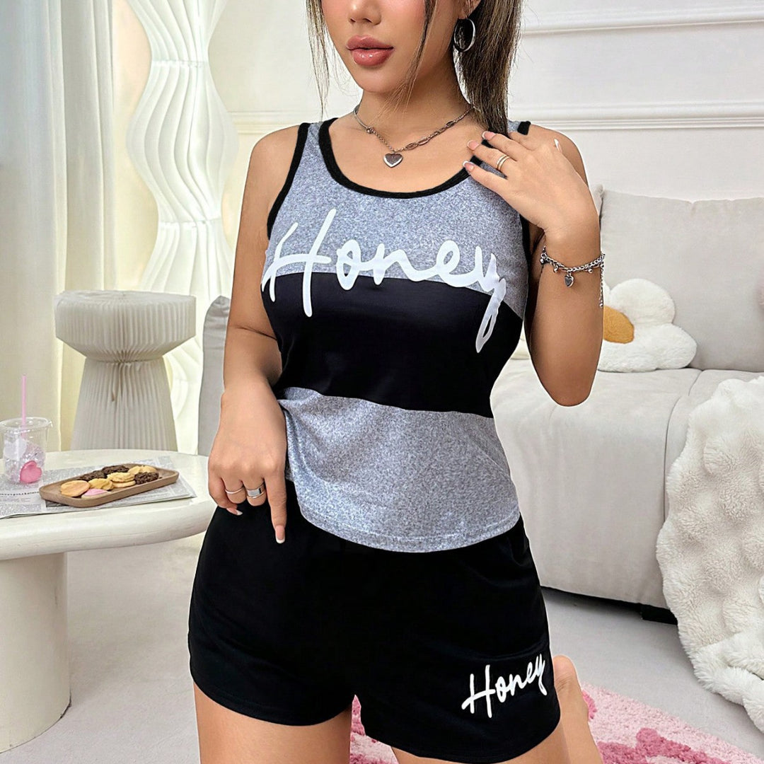 Woman wearing a matching tank top and shorts set with &