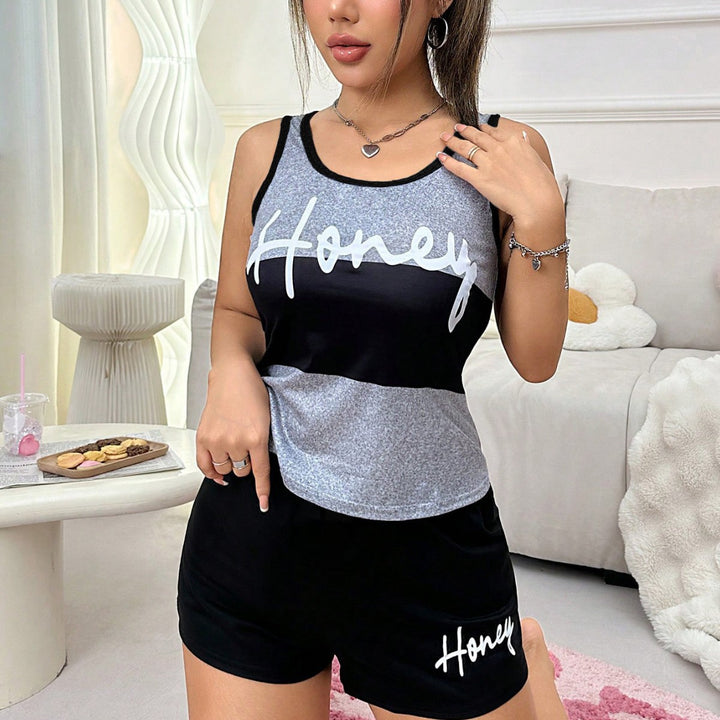 Woman wearing a matching tank top and shorts set with &