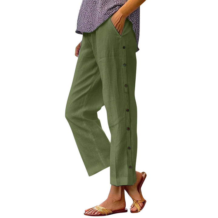 Green pants with buttons worn by a person on a white background