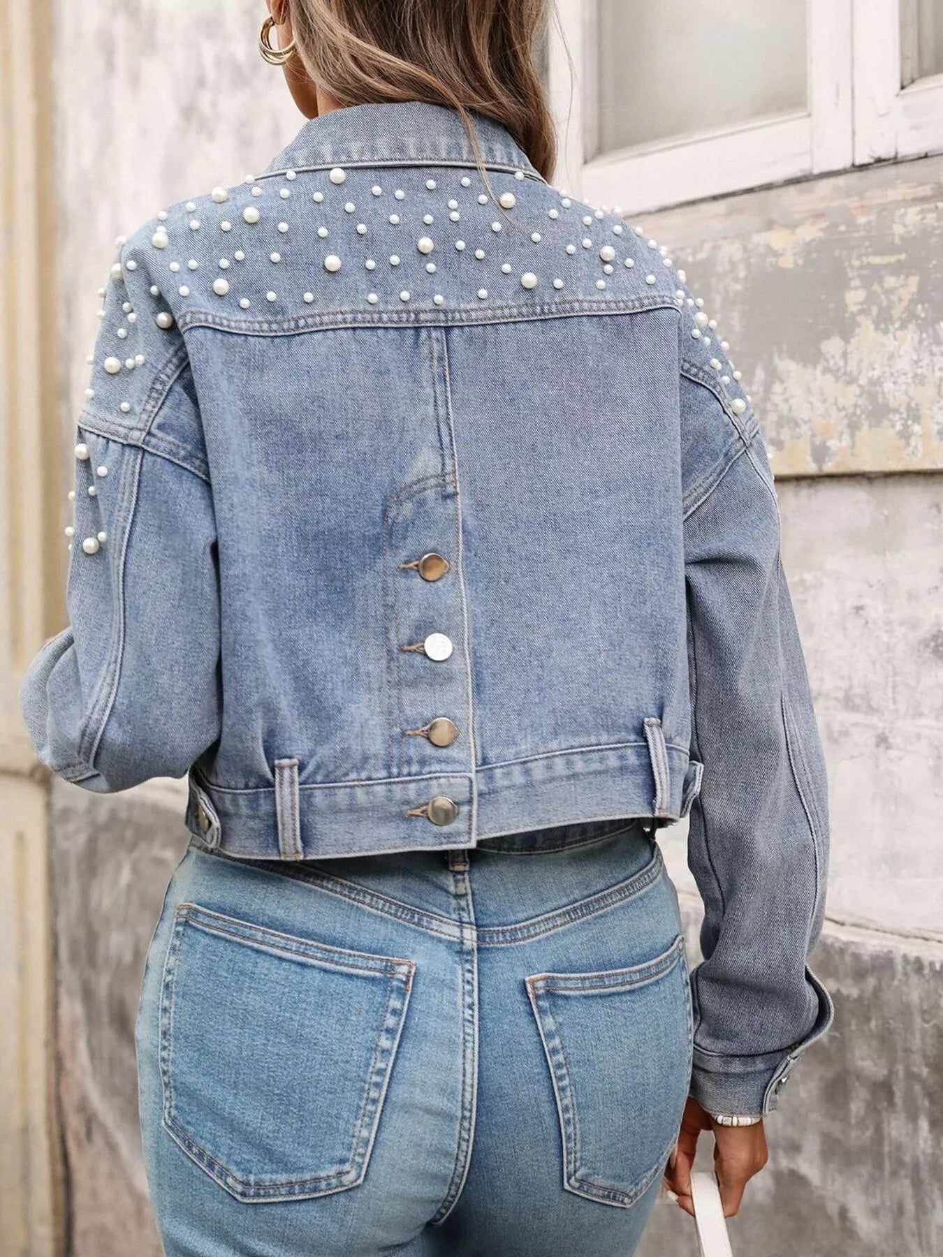 women cropped denim jacket layered over silk top evening casual style