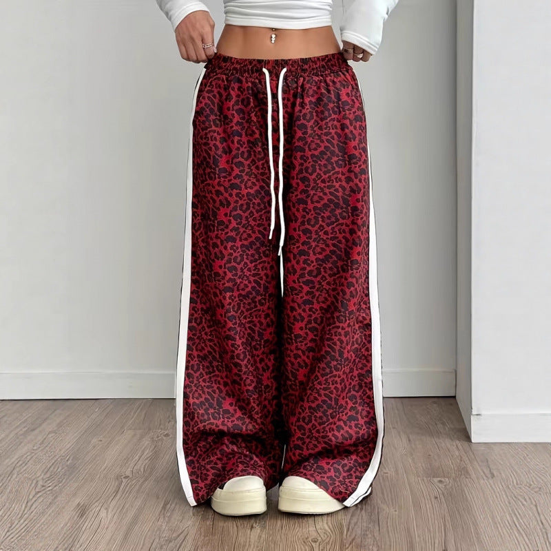 Full body model shot in wide-leg leopard pants with clean white backdrop and modern styling