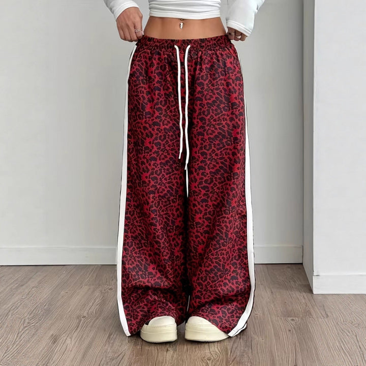Full body model shot in wide-leg leopard pants with clean white backdrop and modern styling