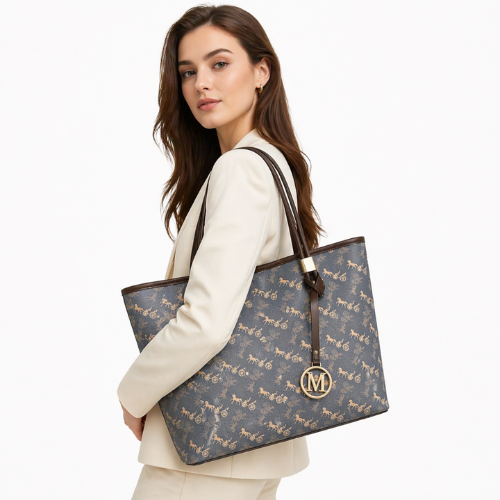 Flat lay of printed tote bag with sunglasses, wallet, phone, and daily essentials.