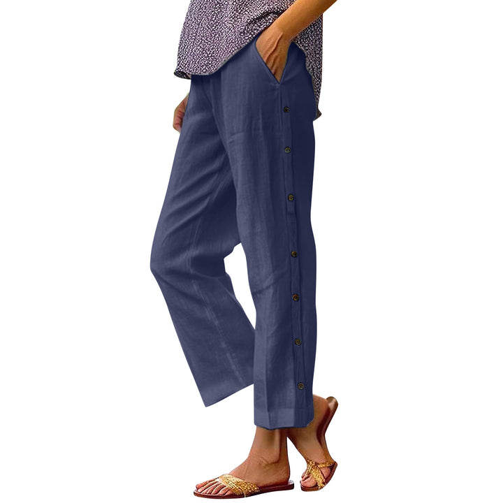 Woman wearing blue pants with buttons on a white background