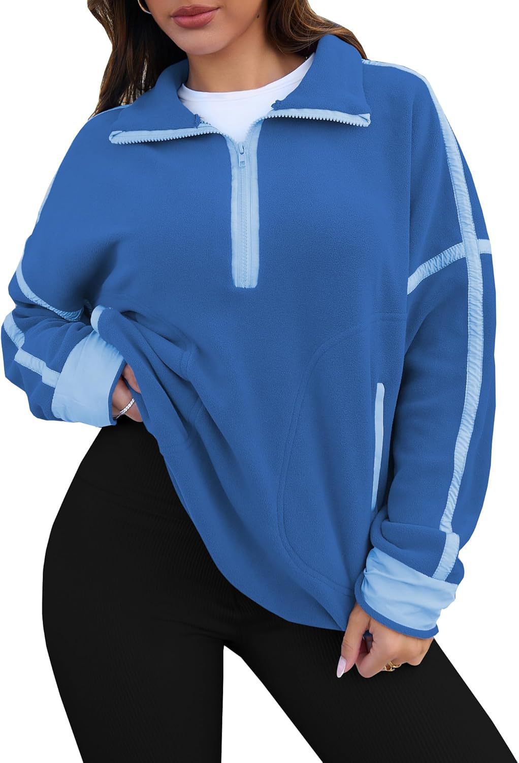 Blue pullover with white accents worn by a person on a white background