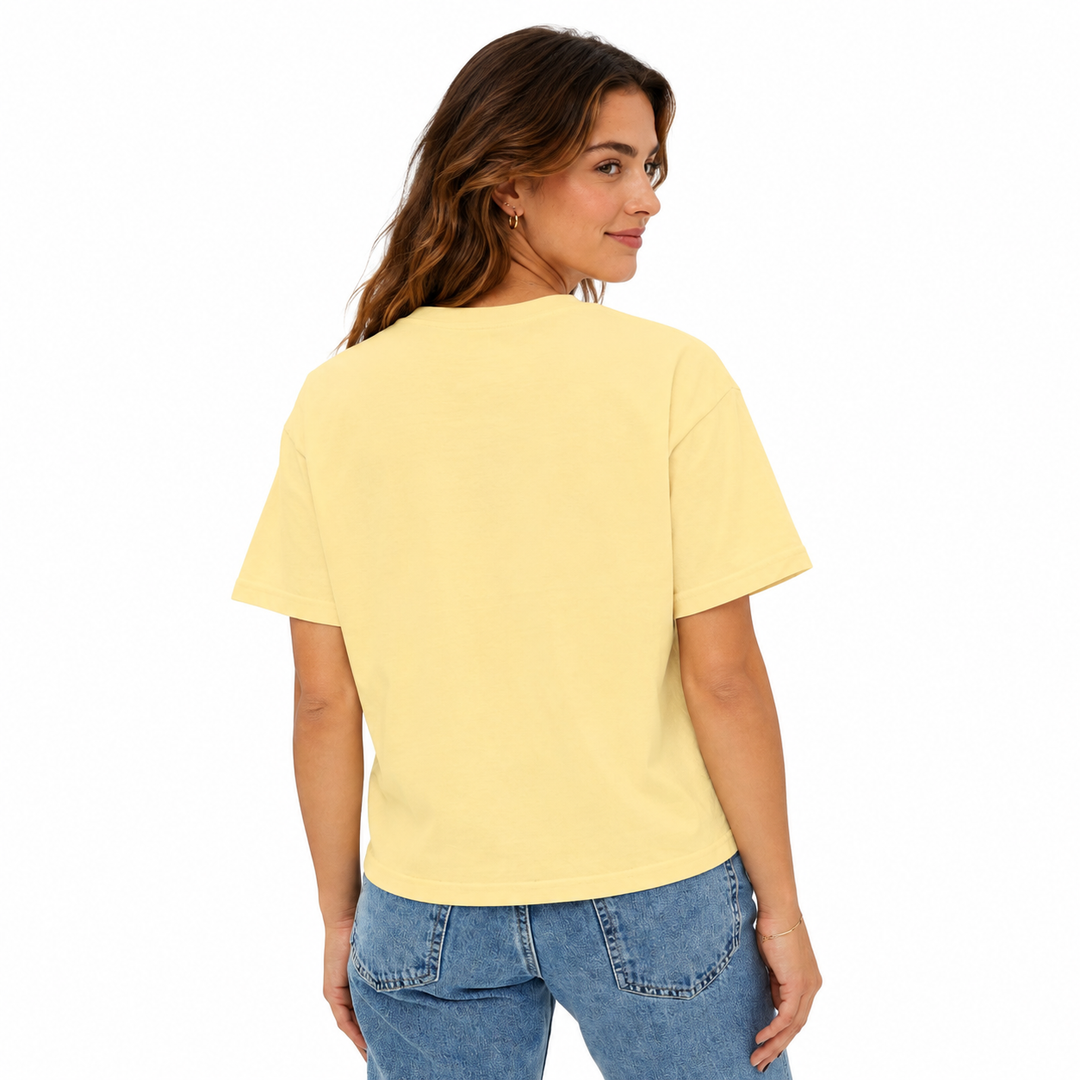 Woman wearing a yellow t-shirt and blue jeans on a white background