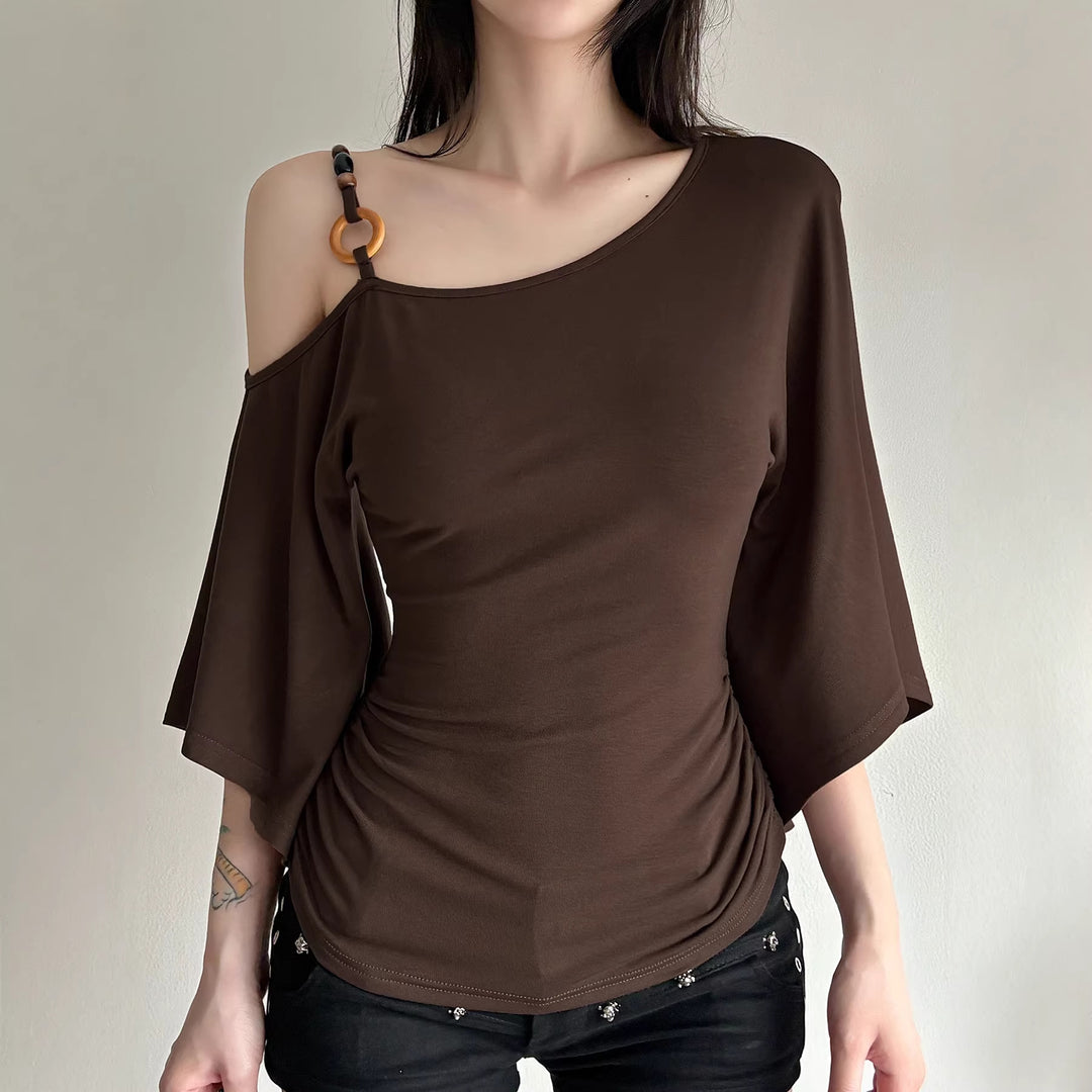 Brown off-shoulder top worn by a person on a plain background