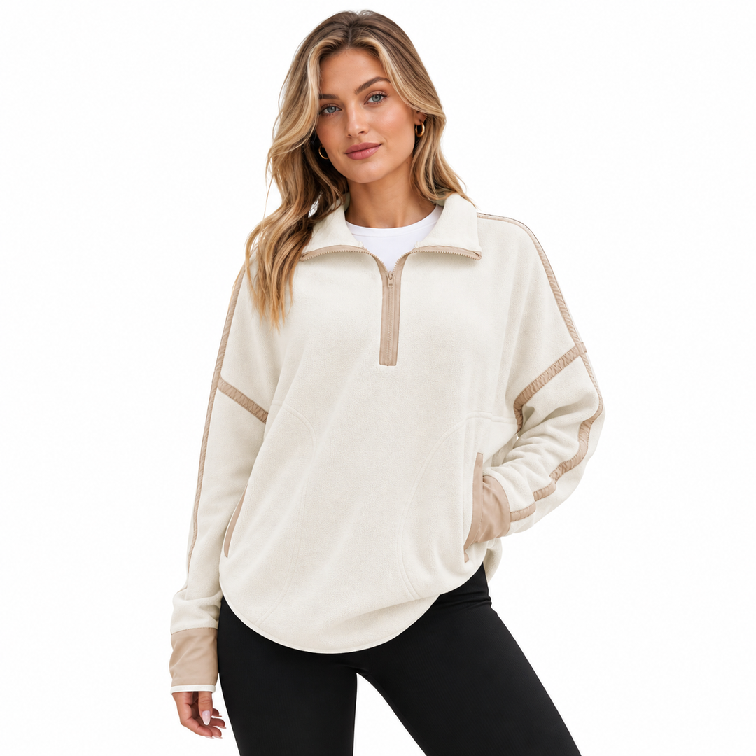 Woman wearing a stand collar zip sweatshirt in a clean studio fashion pose