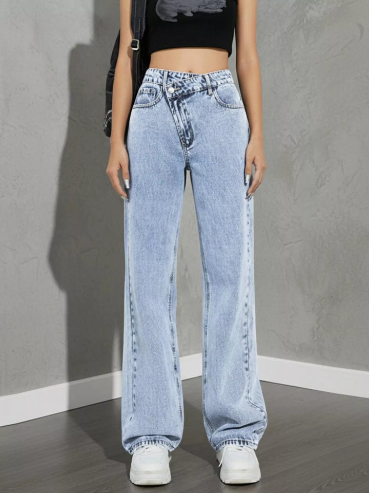 high rise wide leg jeans waistband and belt loop detail in light wash denim paired with shoulder bag for everyday wear