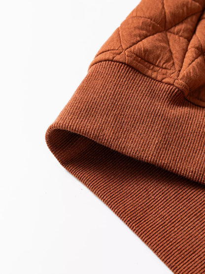 Woman venting half-zip while hiking lightweight warmth quilted sweatshirt