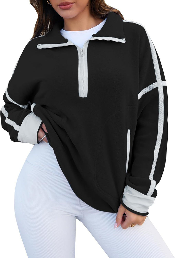 Black zip-up sweatshirt with white accents worn by a person on a white background