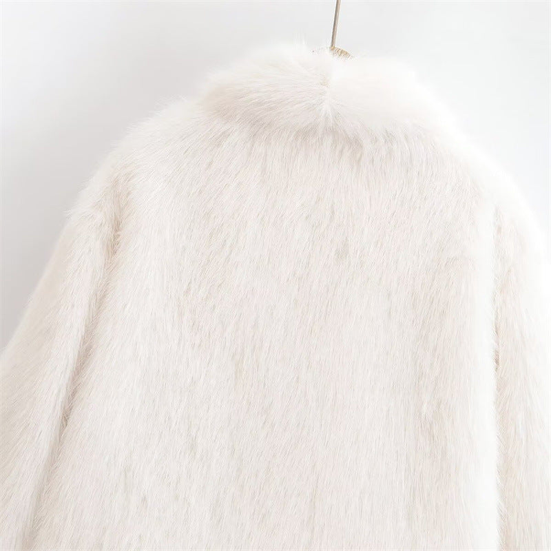 Upper back detail of the white jacket on the hanger, showing the raised collar edge and long fuzzy pile across the shoulders.