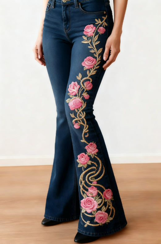 Dark blue slim-fit flared jeans with pink roses and a gold-tone vine print down one leg.