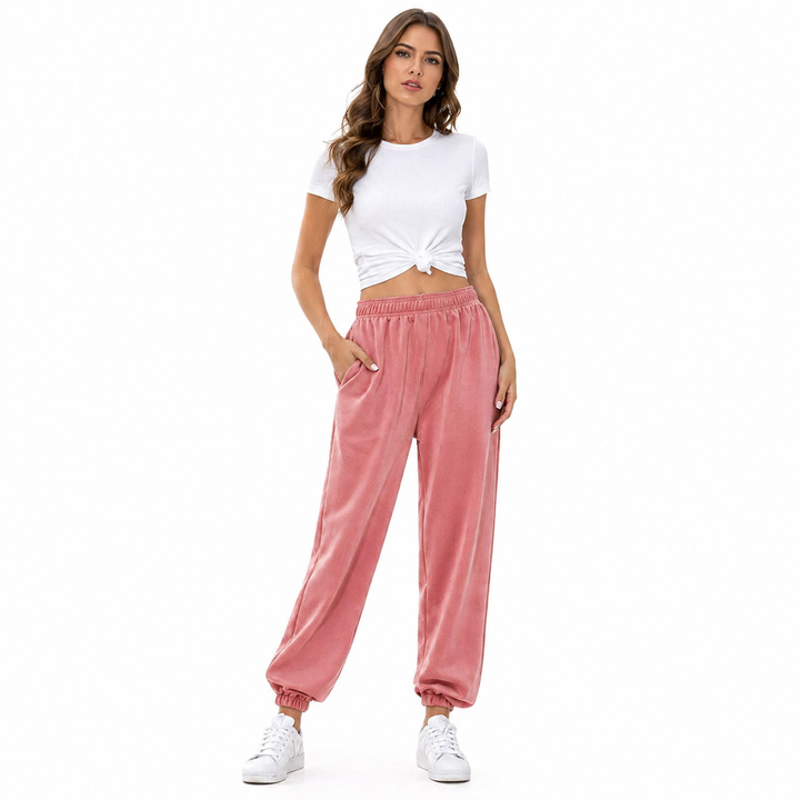 Flat lay of high waist joggers styled with a fitted tank, sneakers and minimal accessories