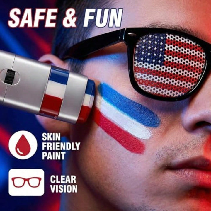 Person with American flag sunglasses and face paint, holding a paintbrush with red, white, and blue colors, against a blurred background.