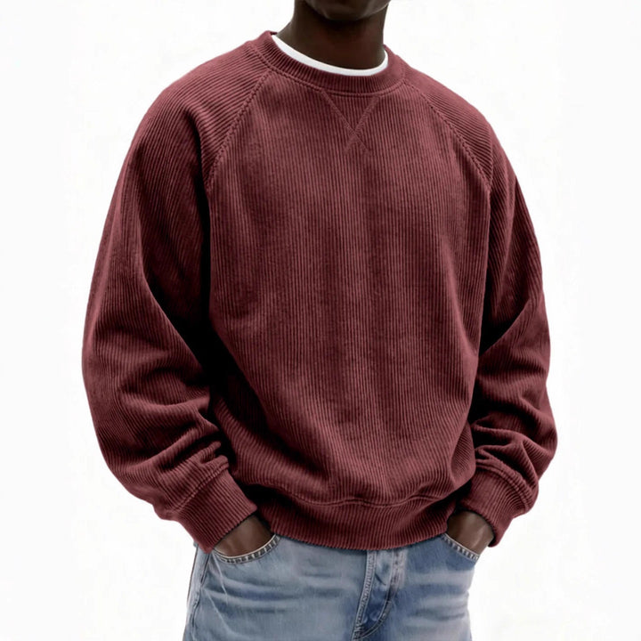Person wearing a maroon corduroy sweatshirt on a white background