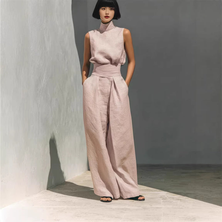 Side view of sleeveless top with structured collar and flowing loose-fit trousers
