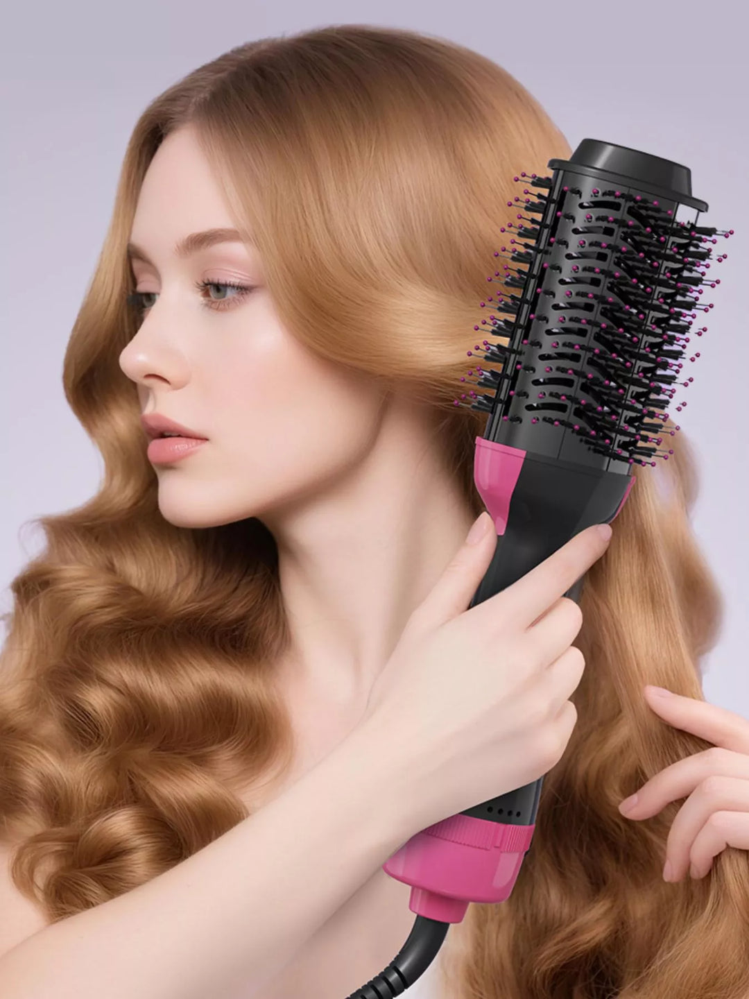 Woman using a pink and black hair styling tool on her hair against a light gray background