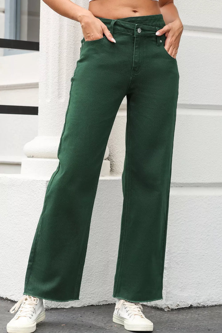 Cross waist jeans paired with heels and a sleek top for a sharper day-to-night outfit