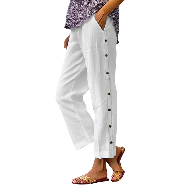 White pants with buttons worn by a person on a white background