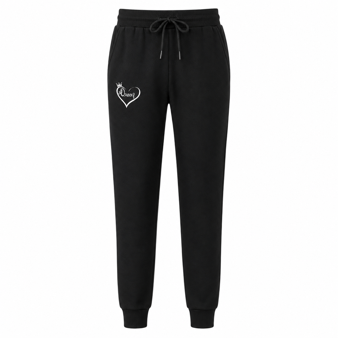 Women black sweatpants with elastic waist, tapered leg cuffs and subtle Queen heart graphic, styled as cozy casual joggers