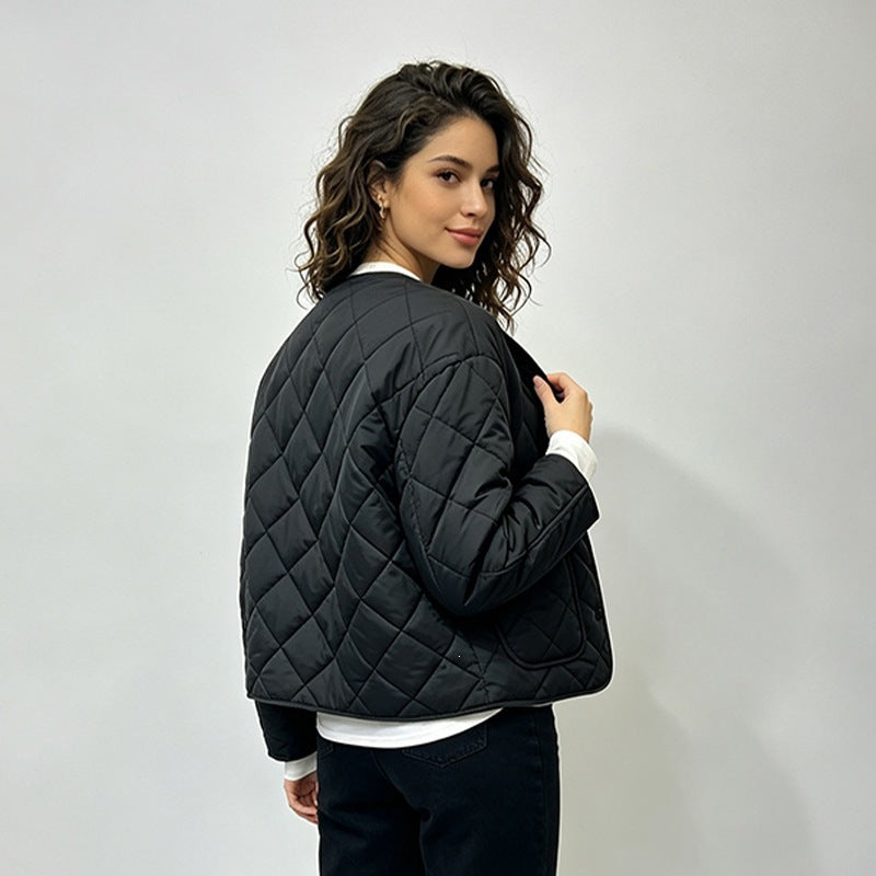 Black quilted jacket showing rear seam and long sleeves