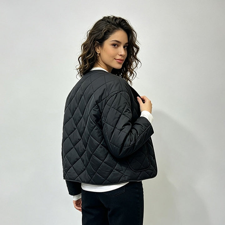 Black quilted jacket showing rear seam and long sleeves